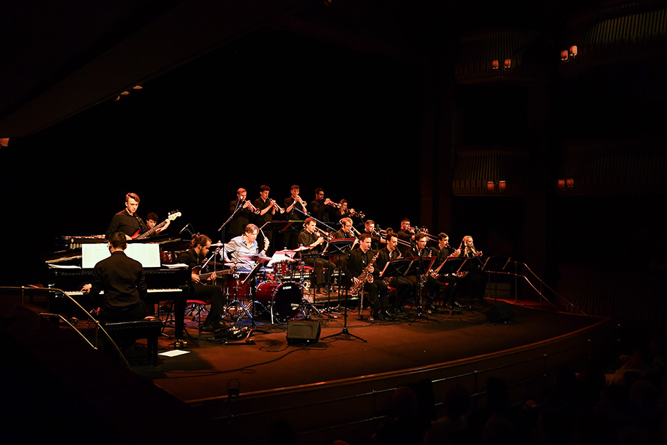 RCM jazz musicians performing on stage in a band with Tommy Igoe